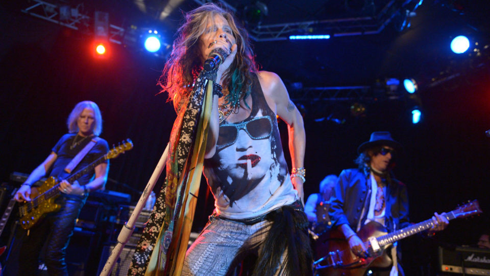 From left, Tom Hamilton, Steven Tyler, and Joe Perry of Aerosmith perform at the Whisky A Go Go on Tuesday, April 8, 2014, in Los Angeles. Aerosmith announced their “Let Rock Rule” summer tour featuring Slash. (Photo by John Shearer/Invision/AP)